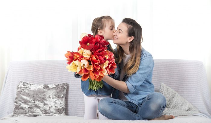 mother-s-day-little-daughter-with-flowers-congratulates-her-mother